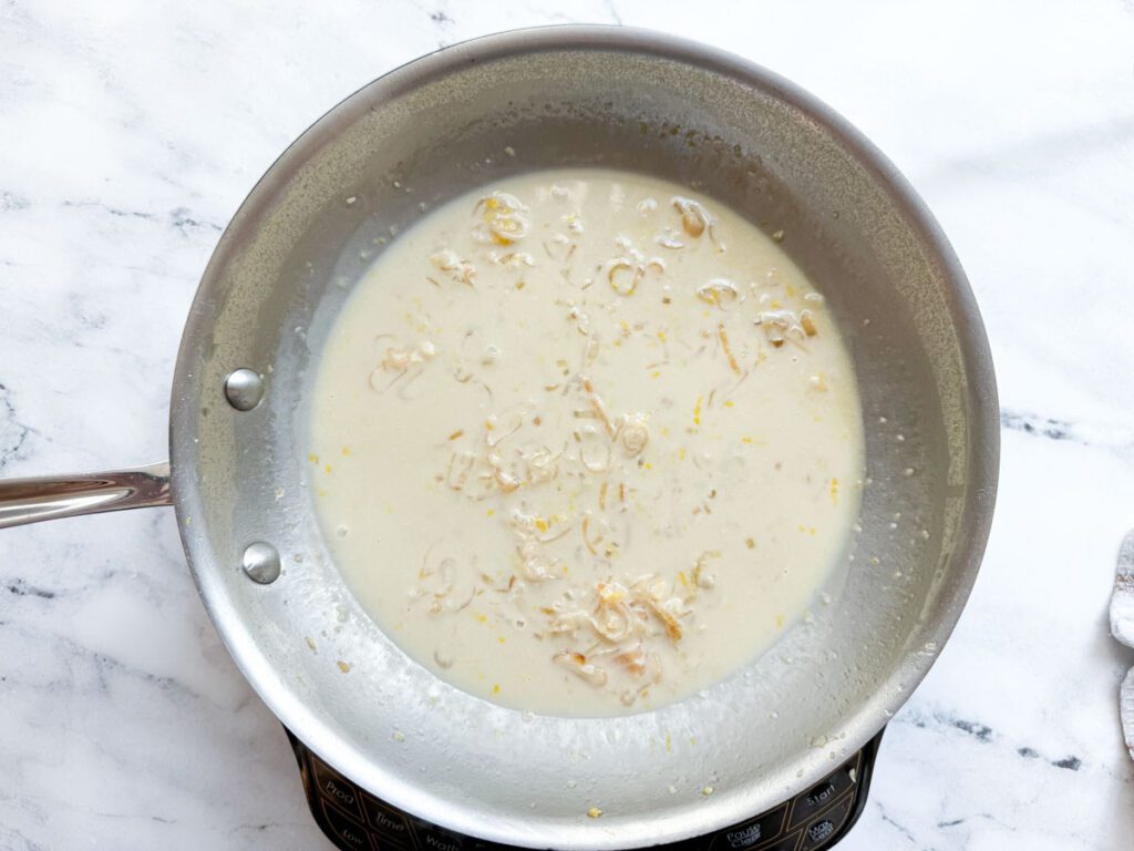 building the cream sauce for smoked salmon and asparagus pasta 