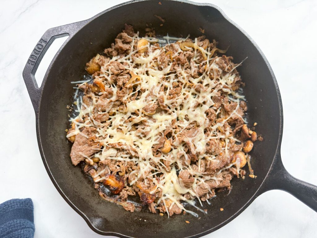 cooked steak topped with melted dairy-free cheese