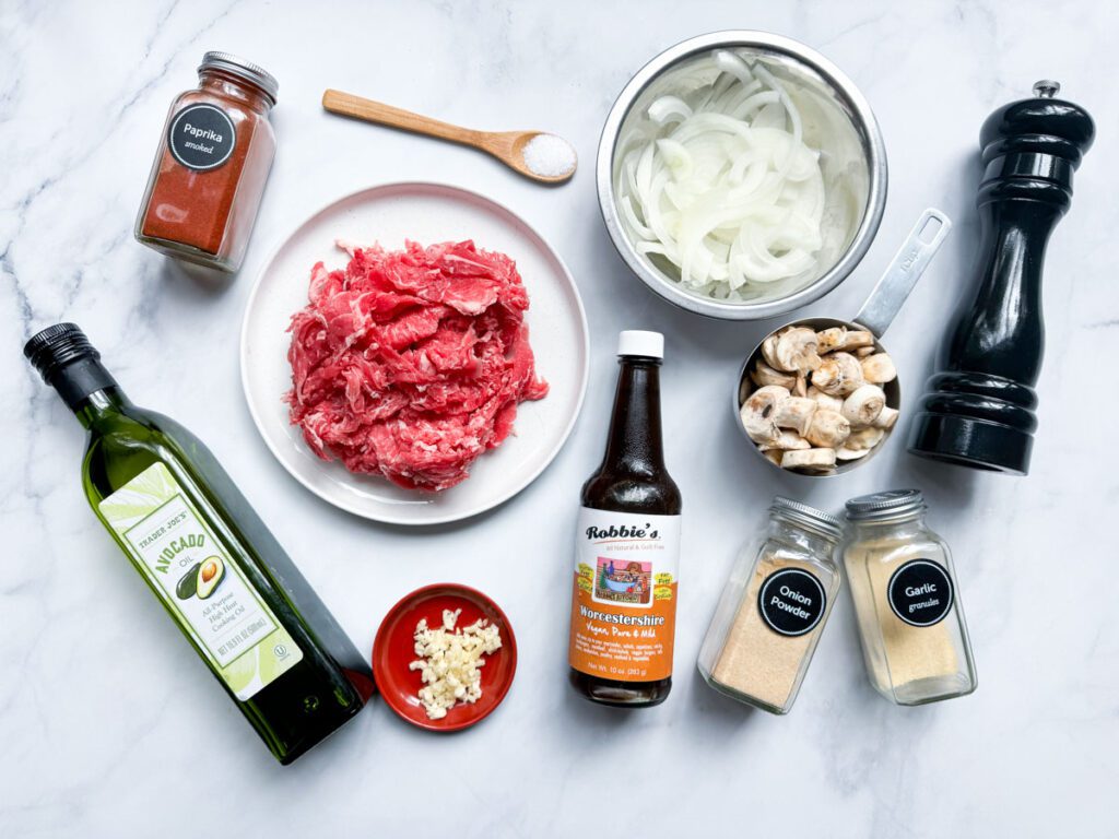 ingredients for philly cheesesteak bowl arranged on counter