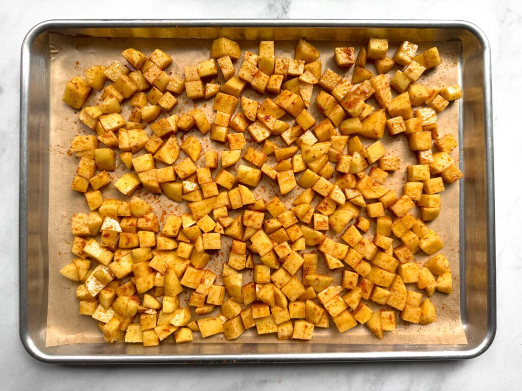 seasoned diced yukon gold potatoes on baking tray